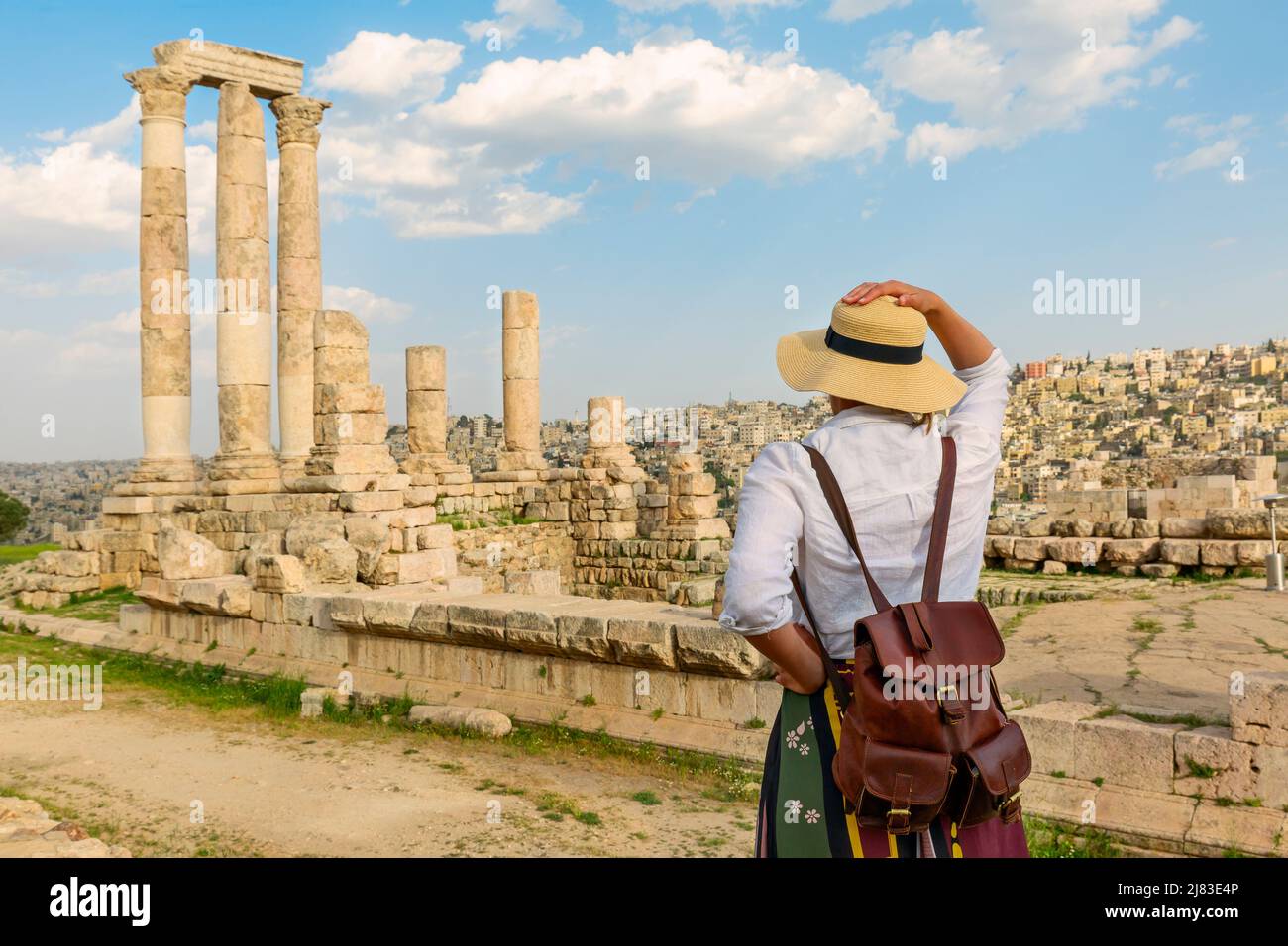 Amman, jordan. travel tourism holiday background -young girl with hat standing looking at the Temple of Hercules of the Amman Citadel complex Stock Photo