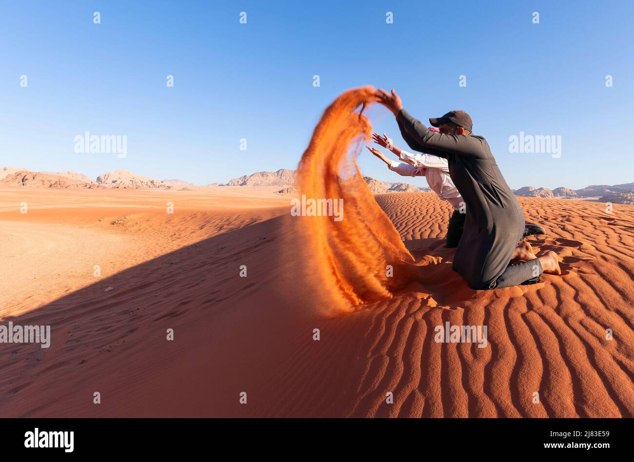Tourist playing sand in Wadi Rum Desert, Jordan Stock Photo
