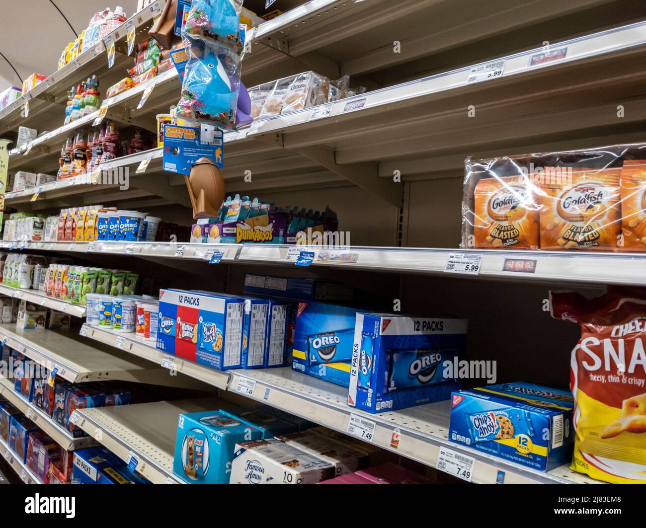 Kirkland, WA USA - circa October 2021: Angled view of low inventory in the snack aisle at SAfeway grocery store, during a back-to-school snack shortag Stock Photo