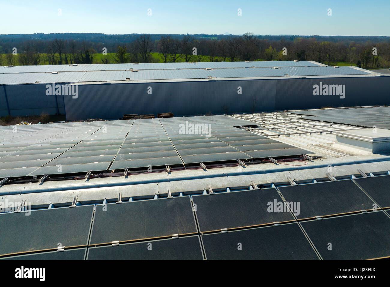 Aerial view of blue photovoltaic solar panels mounted on industrial ...
