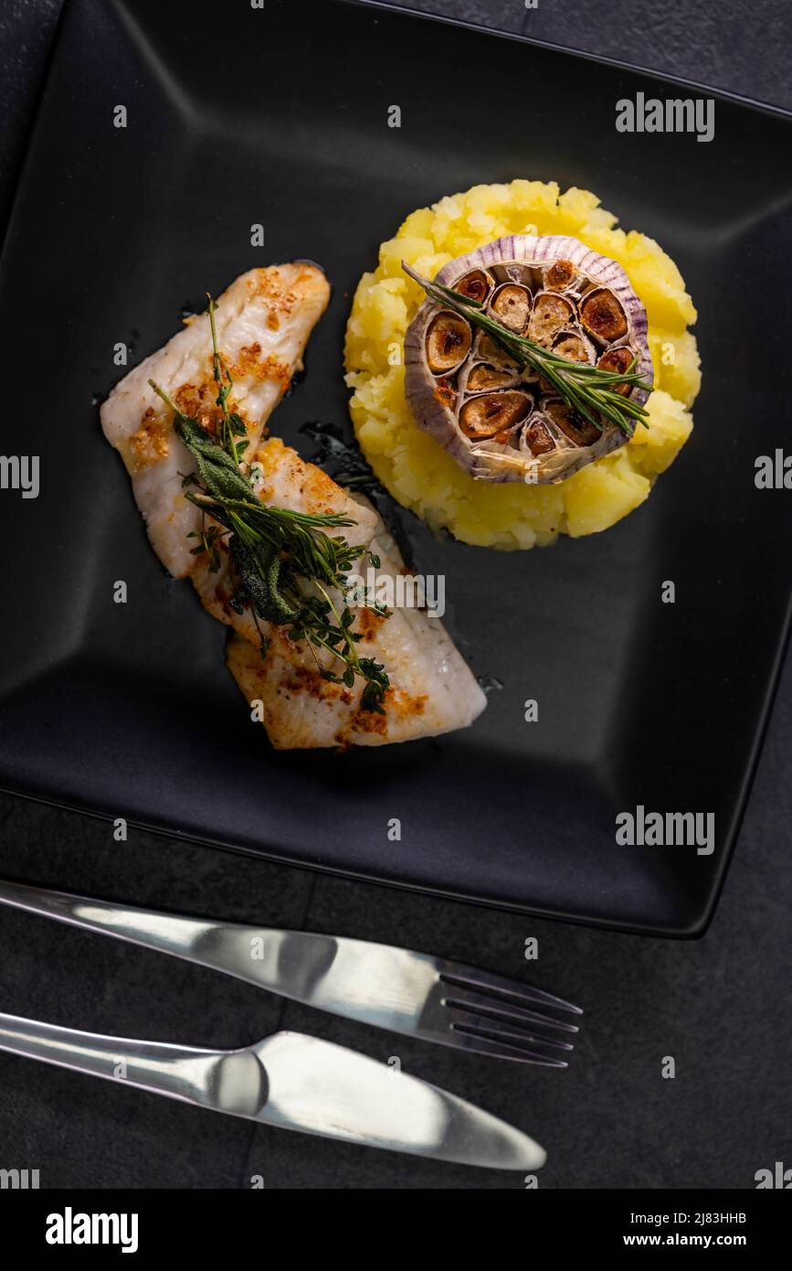 cod fillet with couscous and roasted garlic Stock Photo Alamy