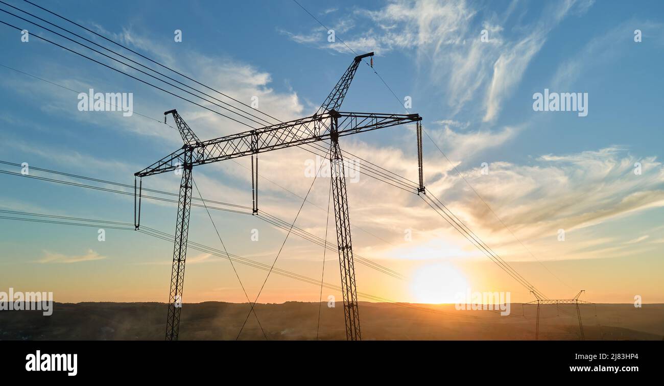 High voltage tower with electric power lines at sunset. Transmission of ...