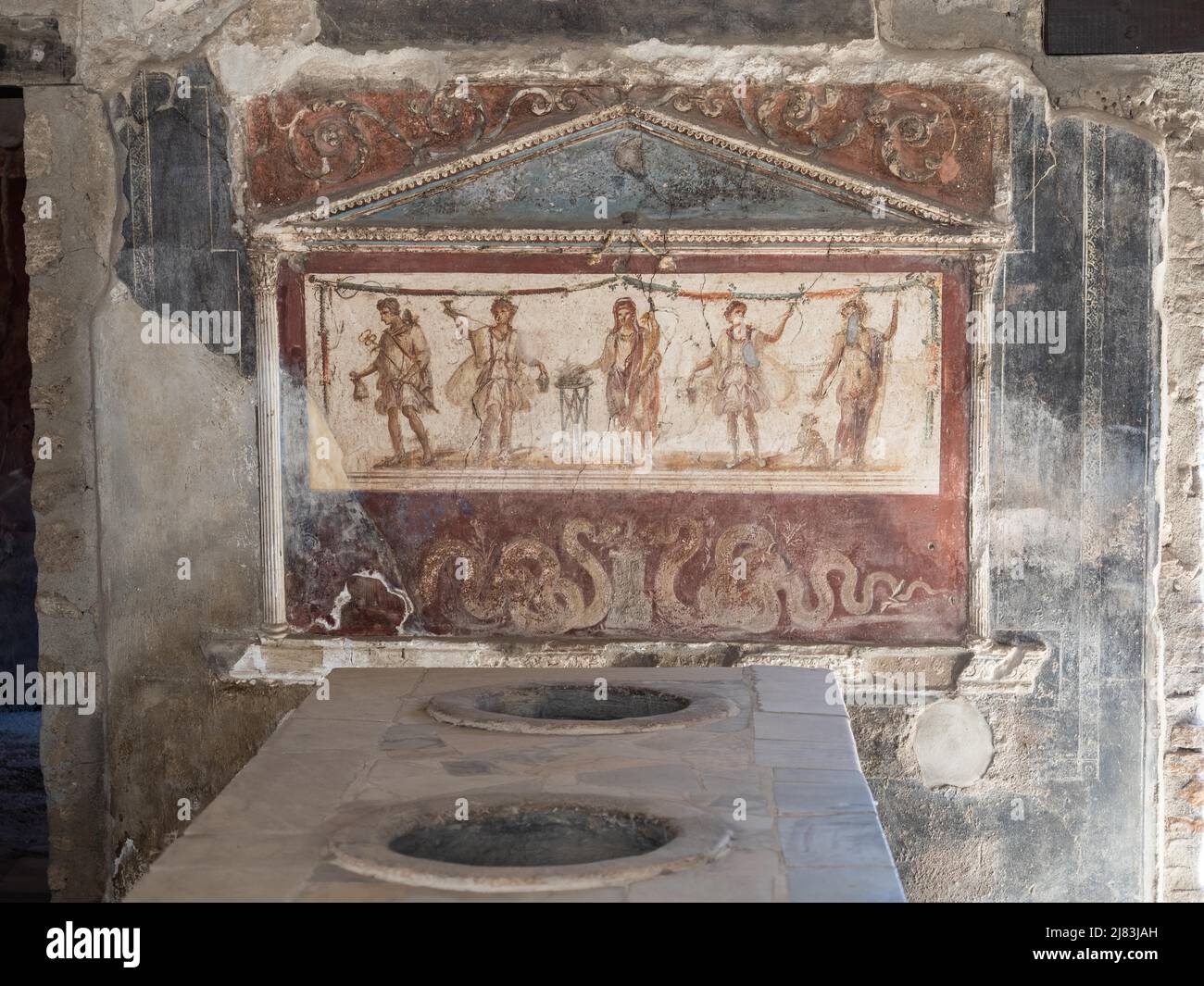 House shrine, lararium in a thermopolium, Pompeii, Campania, Italy Stock Photo