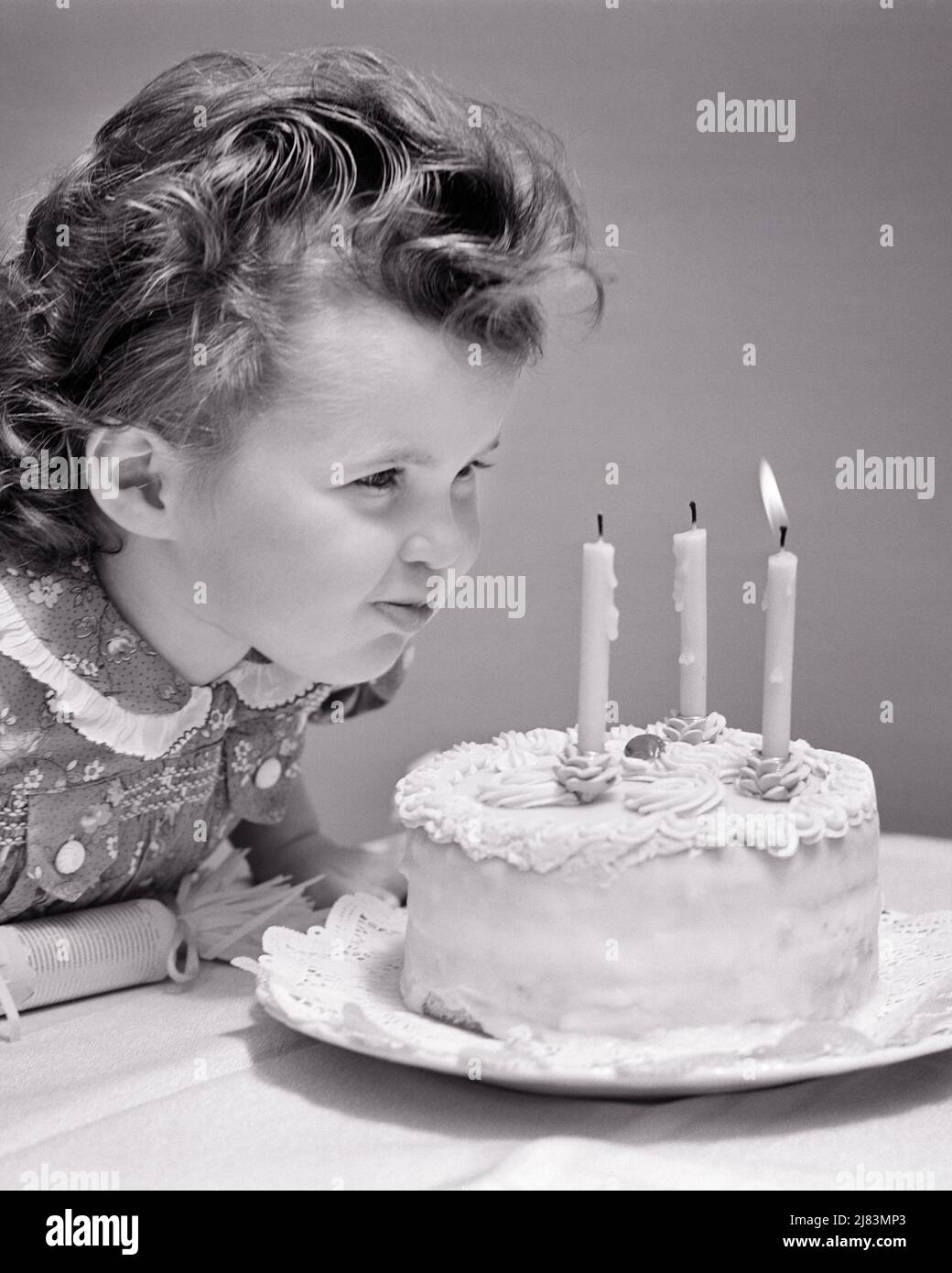 1930s 1940s CUTE THREE YEAR OLD GIRL BLOWING OUT THE CANDLES ON BIRTHDAY CAKE MAKING A WISH - j3381 HAR001 HARS WINNING BLOW STUDIO SHOT CAKES HOME LIFE COPY SPACE WISHING B&W BRUNETTE CELEBRATING HAPPINESS HEAD AND SHOULDERS CURLS EXCITEMENT A BLOWING OUT CONCEPTUAL WISH BLOW OUT PLEASANT AGREEABLE CHARMING GROWTH JUVENILES LOVABLE PLEASING ADORABLE APPEALING BLACK AND WHITE CAUCASIAN ETHNICITY CURLY HAIR HAR001 OLD FASHIONED Stock Photo