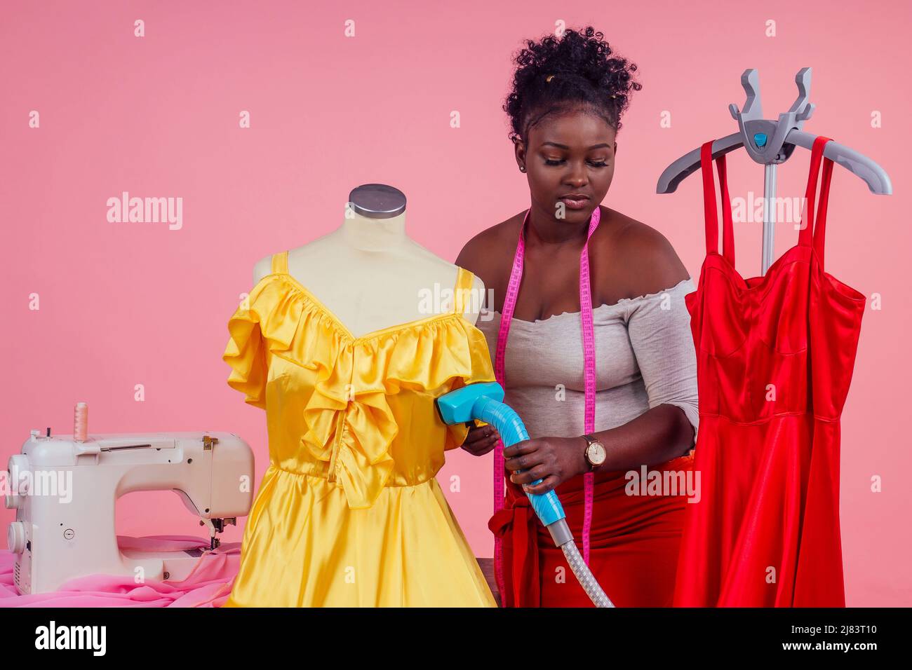african american tailor dressmaker holding vapor device hot steam