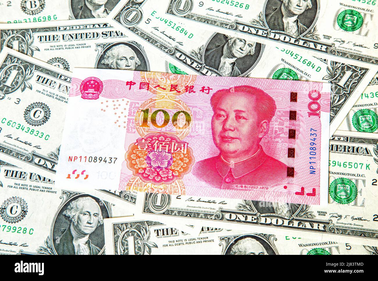 One hundred chinese yuan banknote on the american dollars background