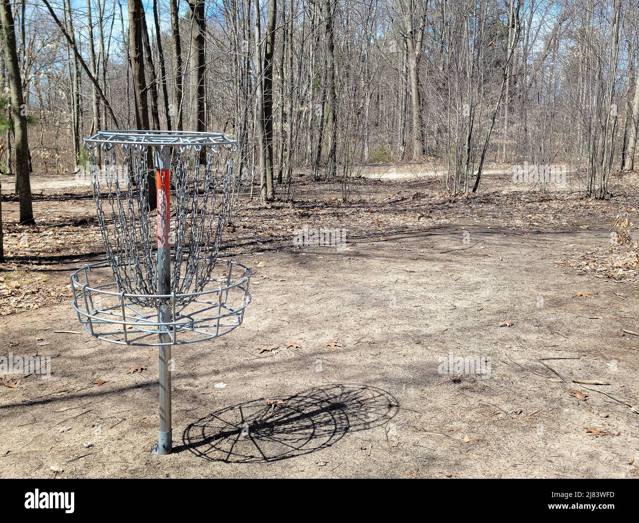 Empty frisbee golf basket in early spring woods Stock Photo Alamy