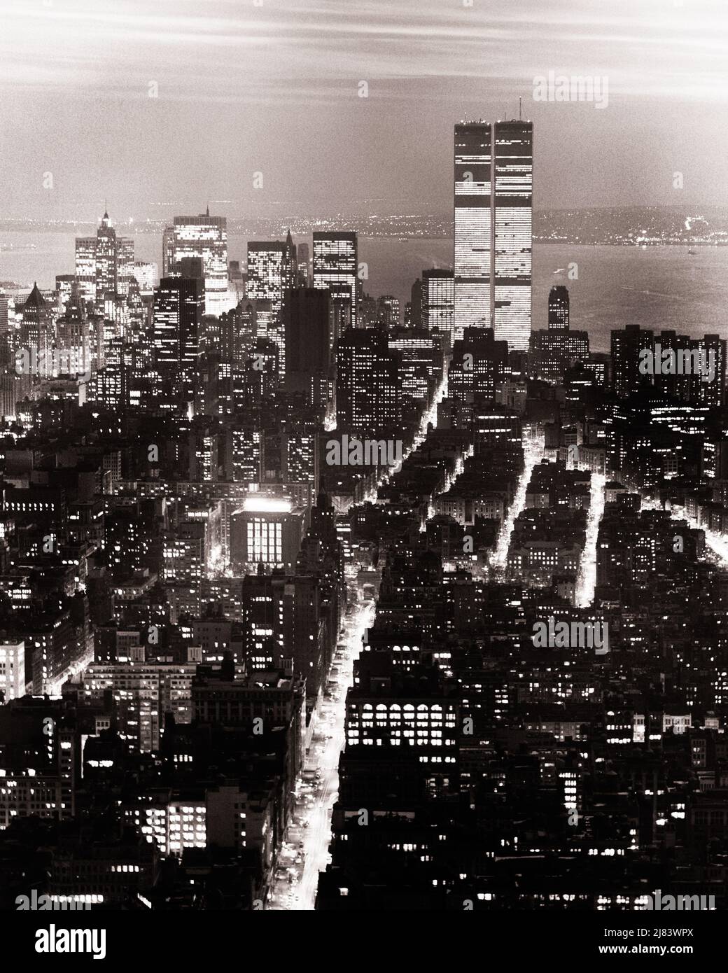 1970s NIGHT SCENE OF SKYLINE OF WESTERN DOWNTOWN MANHATTAN WITH WORLD TRADE CENTER TWIN TOWERS TAKEN FROM MIDTOWN NYC USA - r24504 HAR001 HARS 911 NEW YORK STRUCTURES CITIES TERRORISM BEFORE 911 EDIFICE NEW YORK CITY TRADE WORLD TRADE TOWERS WORLD TRADE CENTER BLACK AND WHITE DESTROYED HAR001 LOWER MANHATTAN OLD FASHIONED SEPTEMBER 11 2001 TOWERS TWIN TOWERS Stock Photo