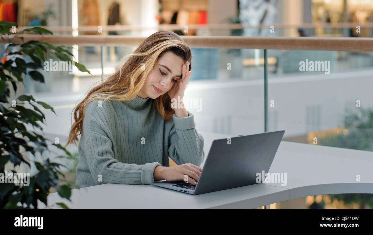 Caucasian business woman receiving refuse letter notice denial from bank problems with work study bad news low grade result sitting in cafe office Stock Photo