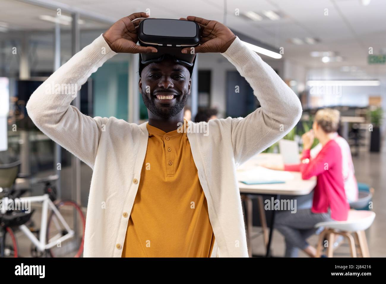 Portrait of happy african american businessman wearing virtual reality ...