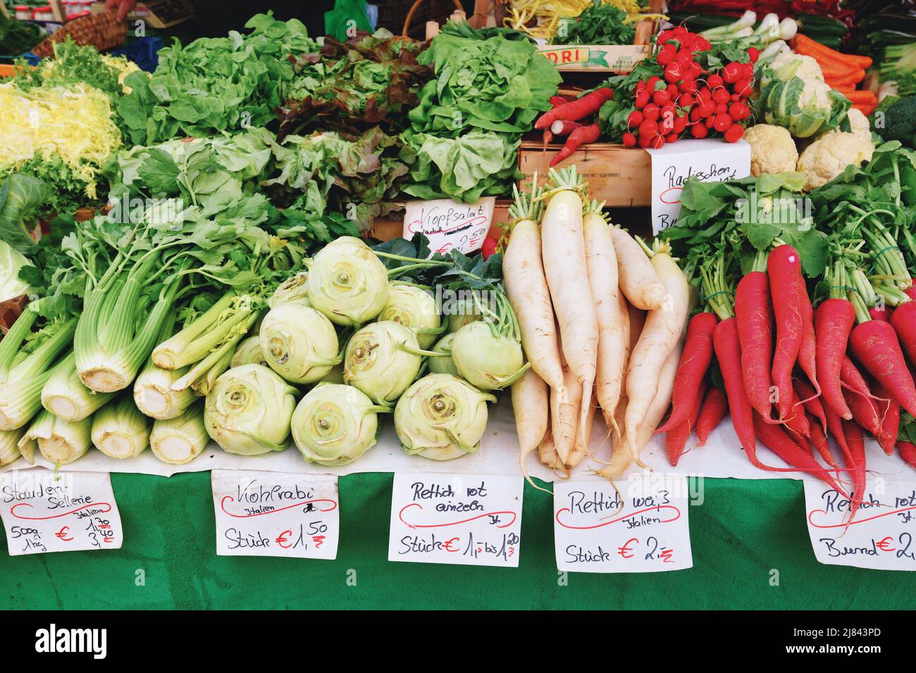 Freiburg, Germany - April 2022: Vegetables like celery, radish or lettuce at market sale booth Stock Photo