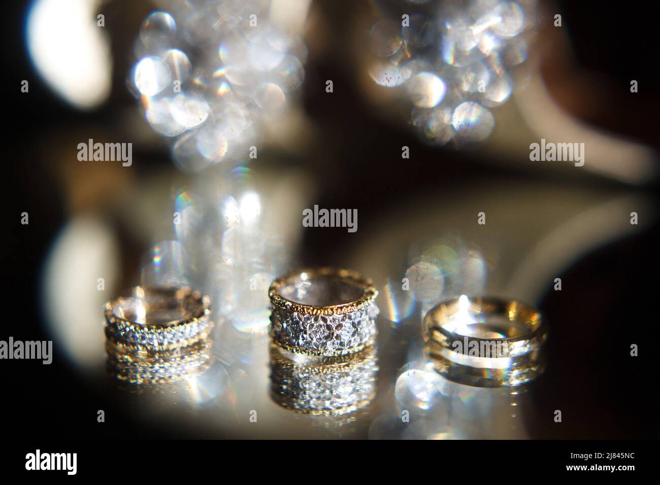 Three wedding rings on a mirror. Wedding preparations Stock Photo Alamy