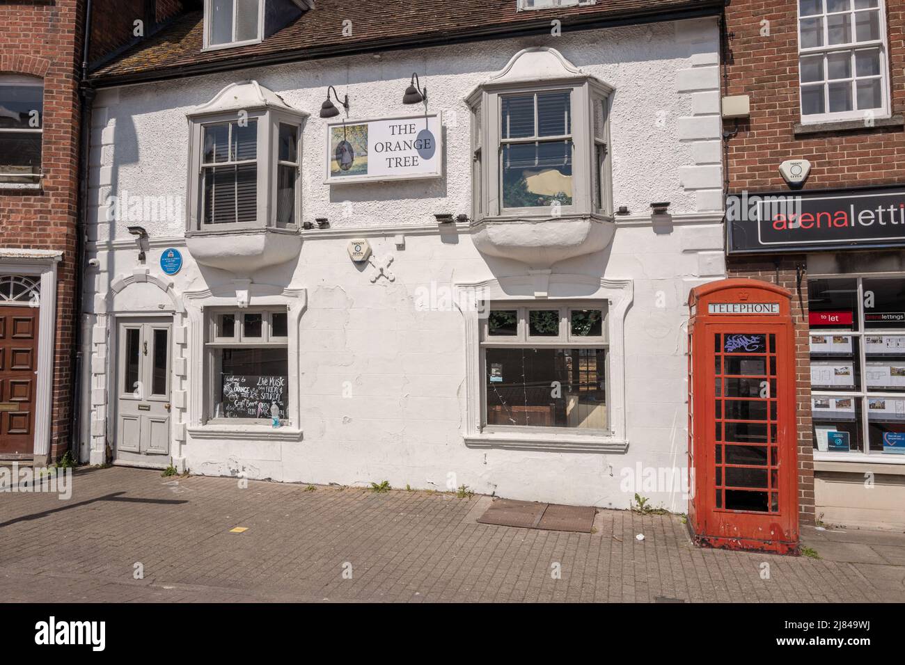 The white washed pub, The Orange Tree with red telephone box situated in the city of Hereford. Stock Photo