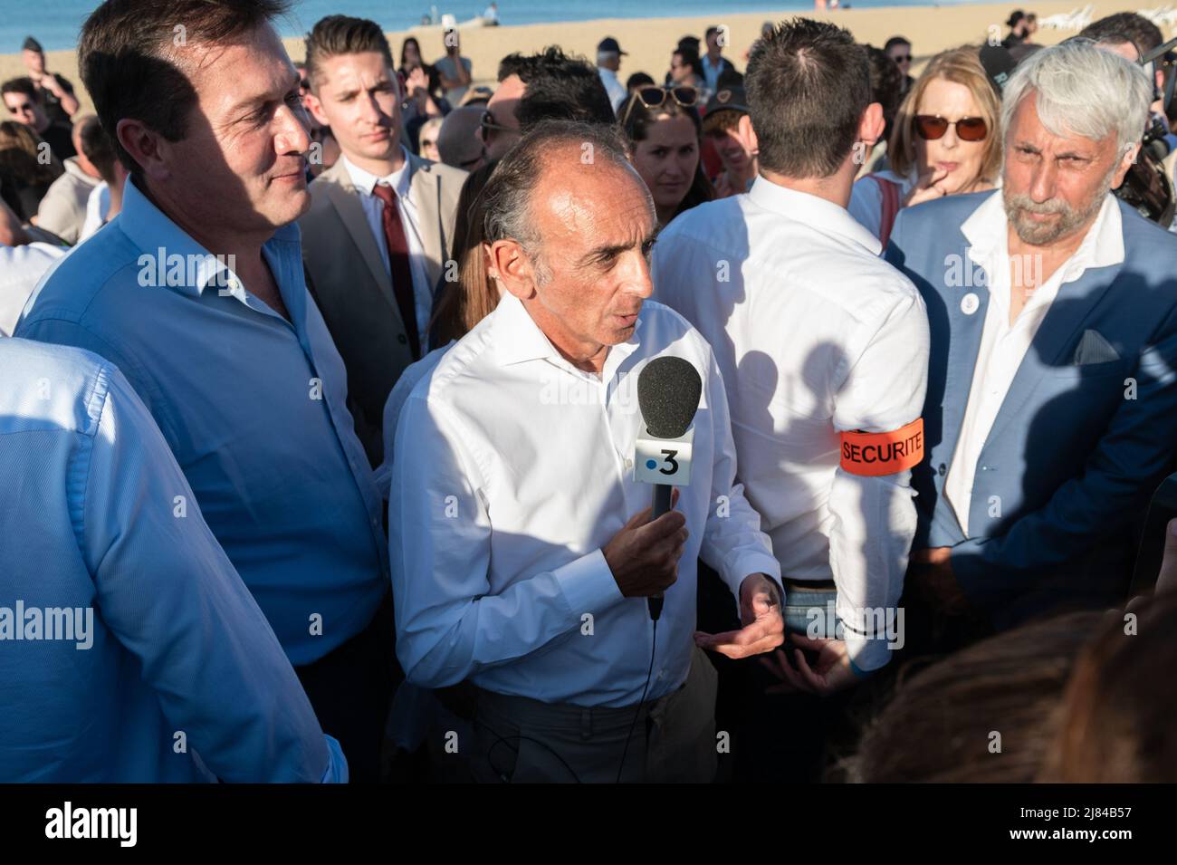 Cogolin, France. 12th May, 2022. Eric Zemmour answers the press after his speech. Eric Zemmour announced in Cogolin (Var) that he is a candidate for the post of deputy of the 4th constituency in the Var in the area of Saint-Tropez. On the beach of the Marines in Cogolin he made his candidacy official in the company of the other candidates of the Reconquete! party. Credit: SOPA Images Limited/Alamy Live News Stock Photo