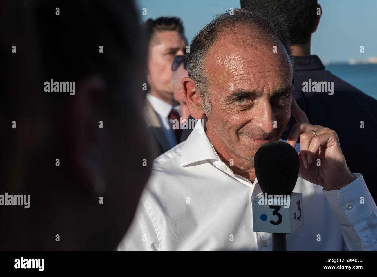 Cogolin, France. 12th May, 2022. Eric Zemmour answers the press after his speech. Eric Zemmour announced in Cogolin (Var) that he is a candidate for the post of deputy of the 4th constituency in the Var in the area of Saint-Tropez. On the beach of the Marines in Cogolin he made his candidacy official in the company of the other candidates of the Reconquete! party. Credit: SOPA Images Limited/Alamy Live News Stock Photo