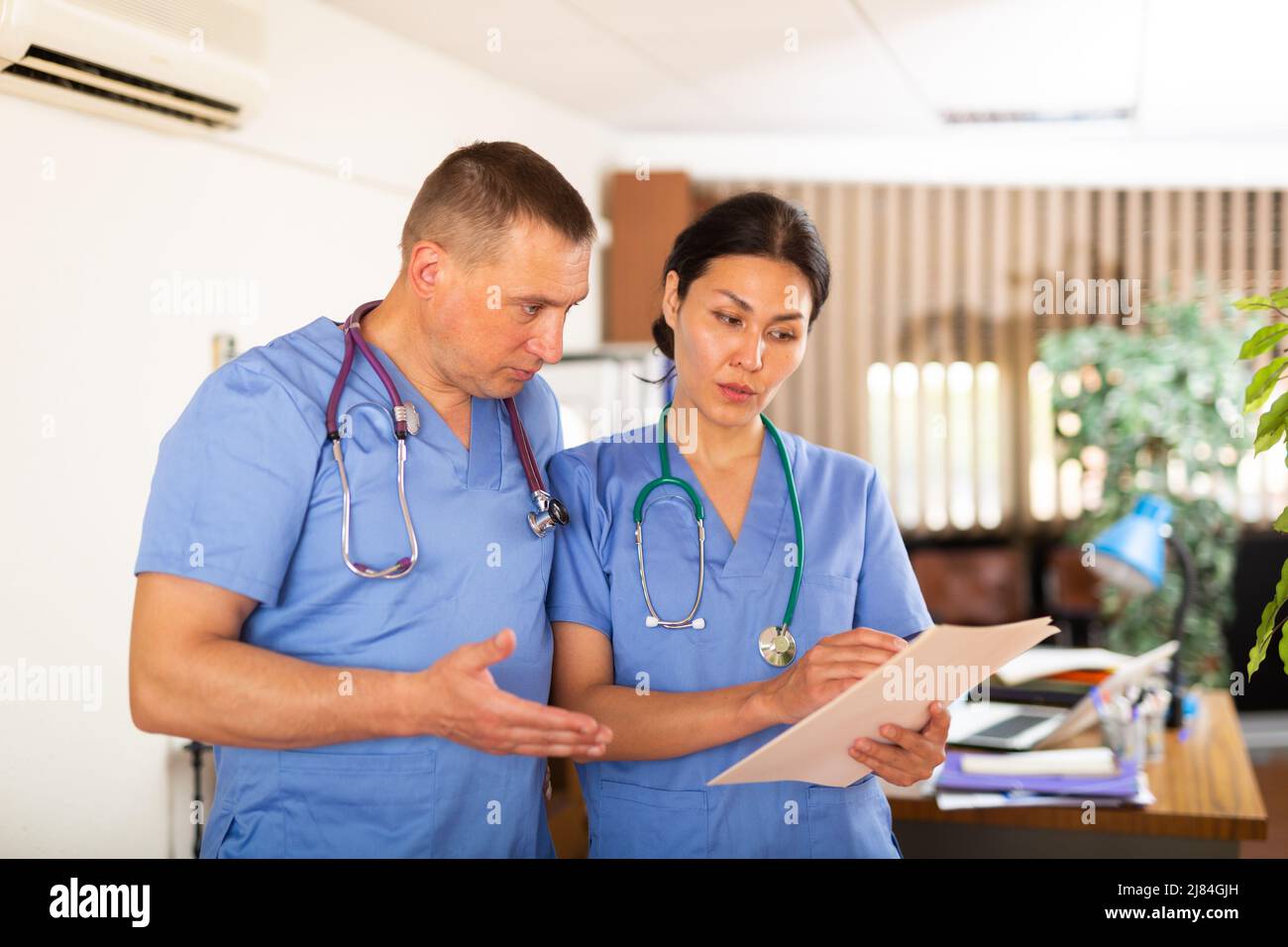 Two fellow doctors discussing of clinical diagnosis of patient Stock ...