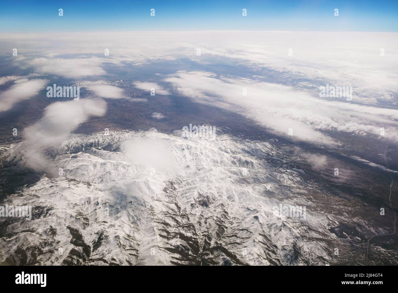 Aerial view of snowy mountains with clouds Stock Photo - Alamy