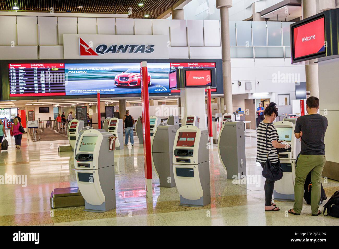 Brisbane Australia,Airport BNE domestic terminal,self-service kiosks kiosk Qantas airline airlines,carrier,logo ticketing man woman couple travelers Stock Photo