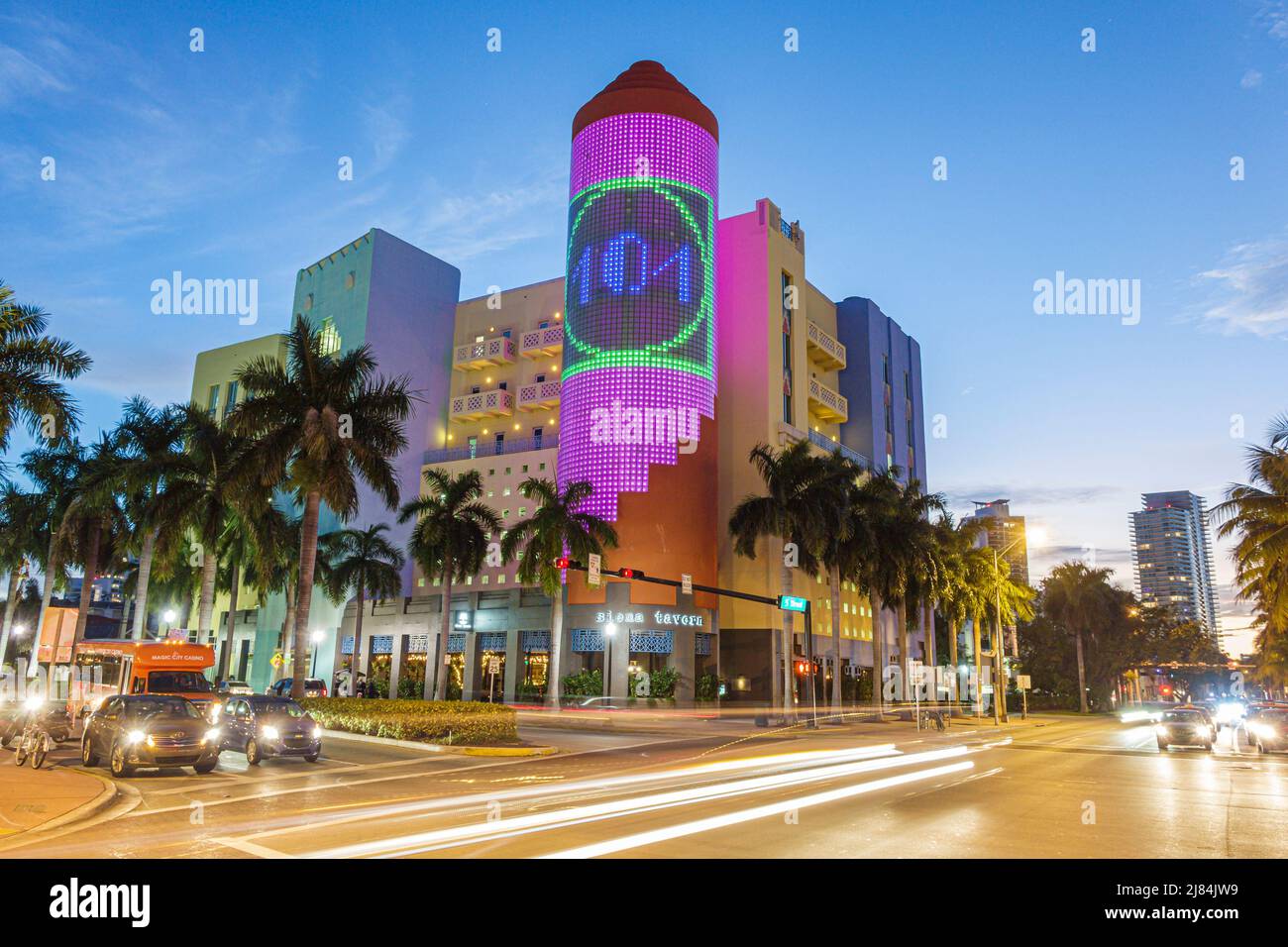 Miami Beach Florida,5th Fifth Street,404 Washington building,glass block tower light show night traffic Stock Photo