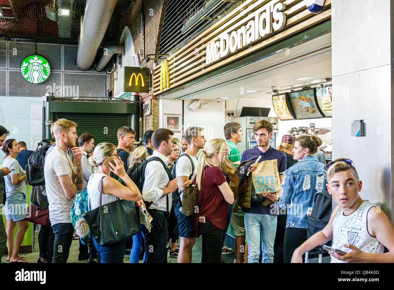 London England,UK,Lambeth South Bank,Waterloo Station,McDonald's fast food restaurant counter,line queue woman man boy teen teens teenager teenagers Stock Photo