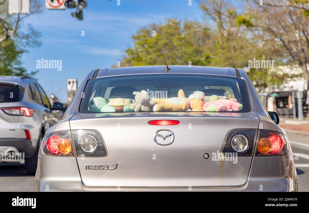 Mazada 3 with a rear window full of stuffed kids toys Stock Photo