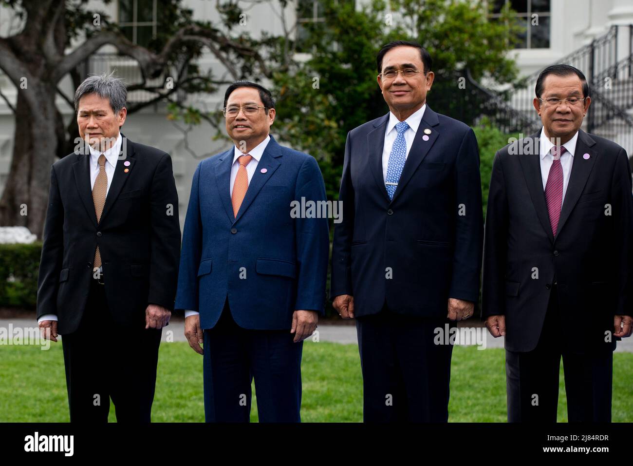 (L to R); Dato Lim Jock Hoi, Secretary-General of the Association for Southeast Asian Nations; Prime Minister of Vietnam Pham Minh Chinh; Prime Minister of Thailand Prayut Chan-o-cha; and Prime Minister of Cambodia Hun Sen; pose with leaders of the US-ASEAN Special Summit during a family photo on the South Lawn of the White House in Washington, DC, USA, 12 March 2022. US President Joe Biden welcomed leaders of ASEAN countries and the ASEAN Secretary General to the White House as the US-ASEAN Special Summit convenes, the second Special Summit since 2016. The summit is expected to address the CO Stock Photo