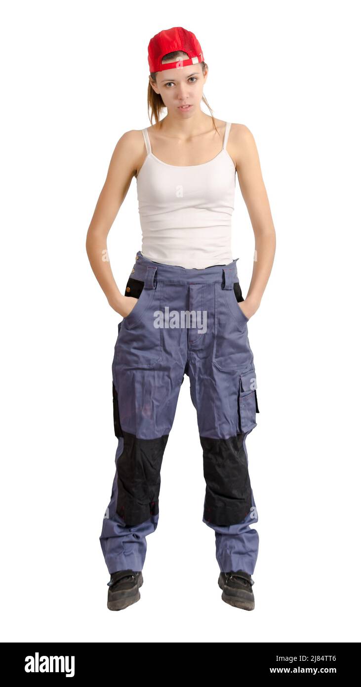 Young girl in overalls standing with his hands in his pockets. Isolated on white Stock Photo