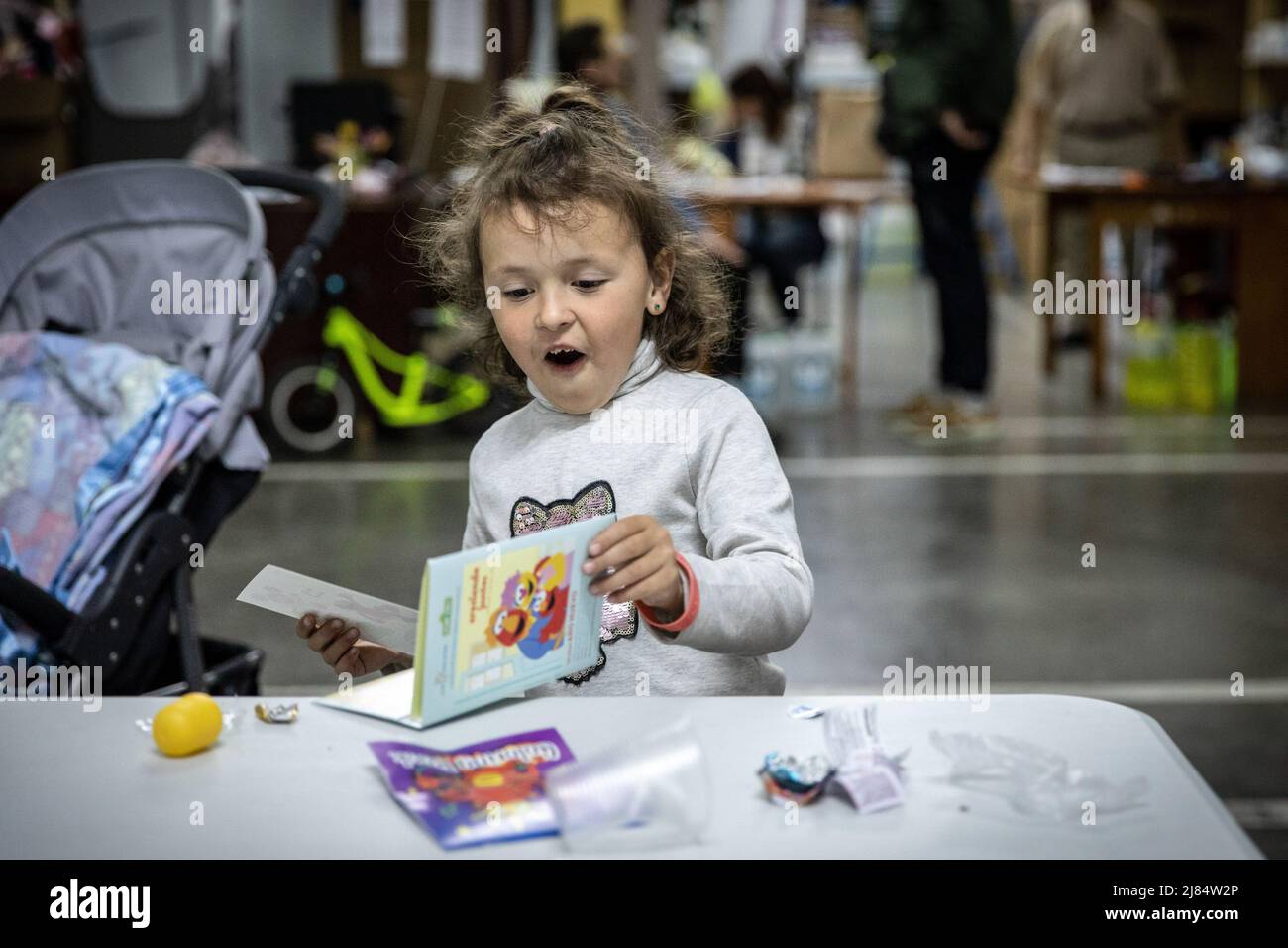 Zaporizhzhia, Ukraine. 11th May, 2022. Sophia seen reading a children's book at an underground refugee shelter, Temporary refugee shelters have been set up in Zaporizhia, as the city has been constantly receiving refugees fleeing from Russian controlled territories in the country's east and south. According to the United Nations, more than 11 million people are believed to have fled their homes in Ukraine since the conflict began, with 7.7 million people displaced inside their homeland. Credit: SOPA Images Limited/Alamy Live News Stock Photo