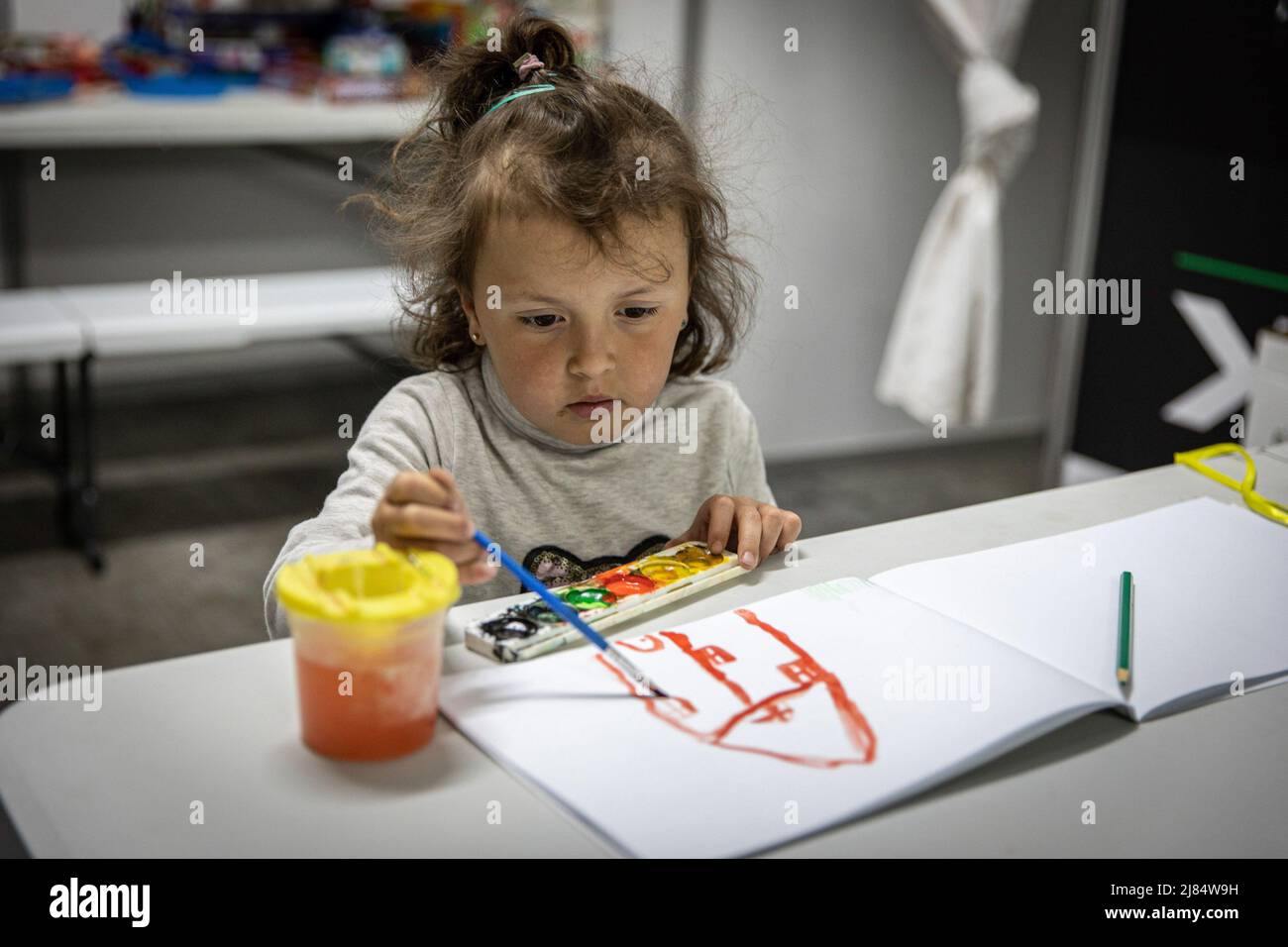 Zaporizhzhia, Ukraine. 11th May, 2022. Sophia seen drawing a house at an underground refugee shelter. Temporary refugee shelters have been set up in Zaporizhia, as the city has been constantly receiving refugees fleeing from Russian controlled territories in the country's east and south. According to the United Nations, more than 11 million people are believed to have fled their homes in Ukraine since the conflict began, with 7.7 million people displaced inside their homeland. (Photo by Alex Chan Tsz Yuk/SOPA Images/Sipa USA) Credit: Sipa USA/Alamy Live News Stock Photo