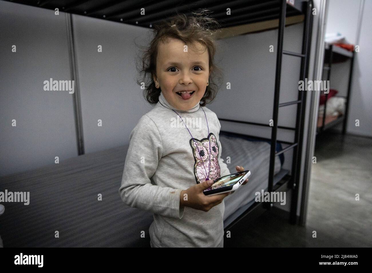 Zaporizhzhia, Ukraine. 11th May, 2022. Sophia plays with a mobile phone at an underground shelter. Temporary refugee shelters have been set up in Zaporizhia, as the city has been constantly receiving refugees fleeing from Russian controlled territories in the country's east and south. According to the United Nations, more than 11 million people are believed to have fled their homes in Ukraine since the conflict began, with 7.7 million people displaced inside their homeland. (Photo by Alex Chan Tsz Yuk/SOPA Images/Sipa USA) Credit: Sipa USA/Alamy Live News Stock Photo