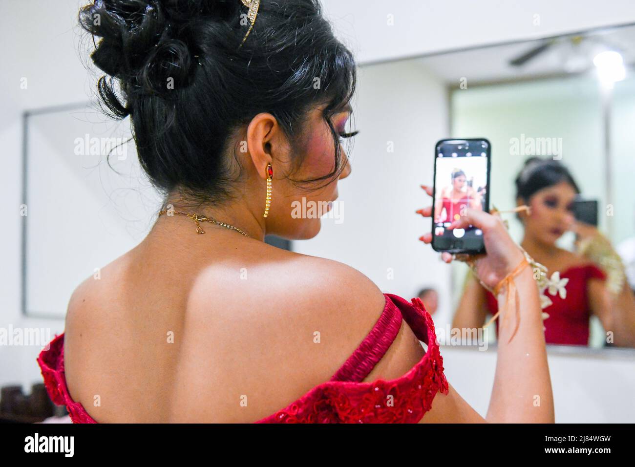 Mexican teen taking a selfie during her Quinceañera that celebrates officially her 15th birthday. This special occasion is celebrated by girls throughout Latin America / Campeche, Mexico Stock Photo
