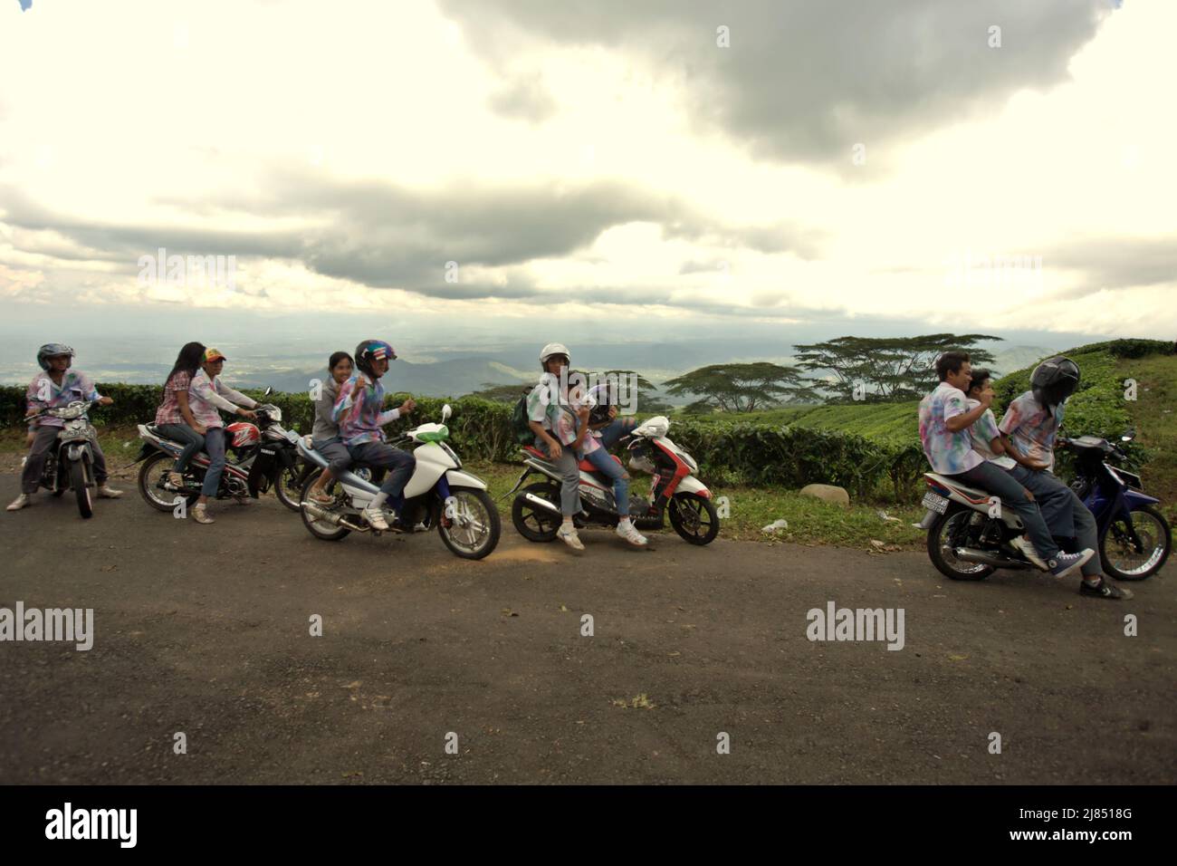 Portrait of high school students as they are celebrating their school graduation by riding through tea plantation in a convoy, wearing school uniforms that had been painted as a tradition, in Pagar Alam, South Sumatra, Indonesia. Stock Photo