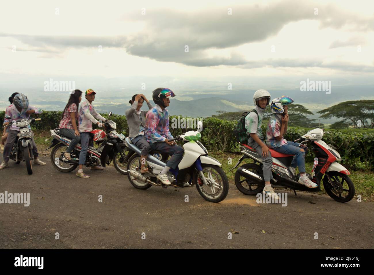 Portrait of high school students as they are celebrating their school graduation by riding through tea plantation in a convoy, wearing school uniforms that had been painted as a tradition, in Pagar Alam, South Sumatra, Indonesia. Stock Photo