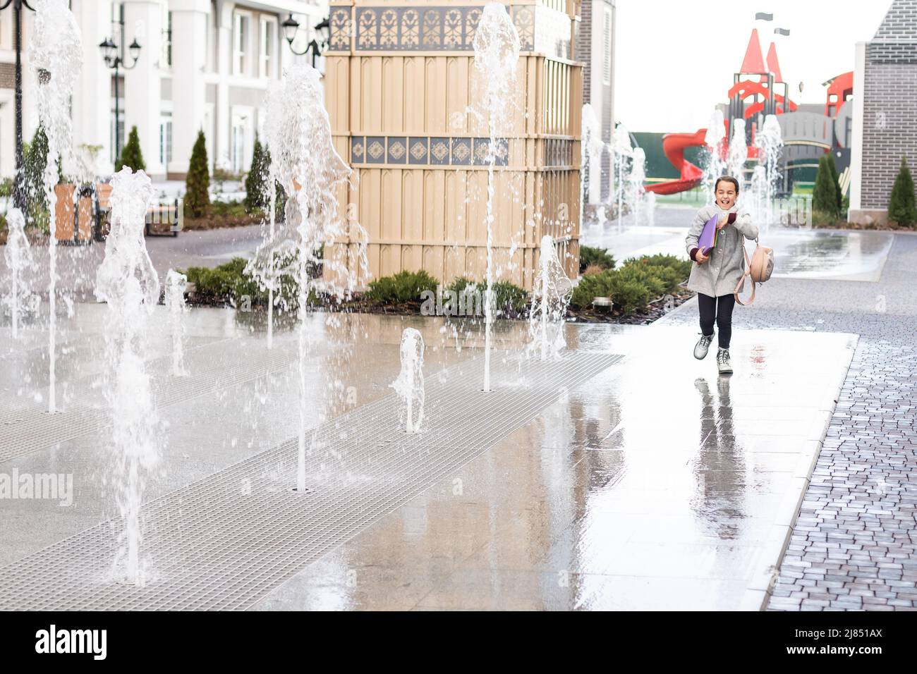 happy little girl running home from school Stock Photo Alamy