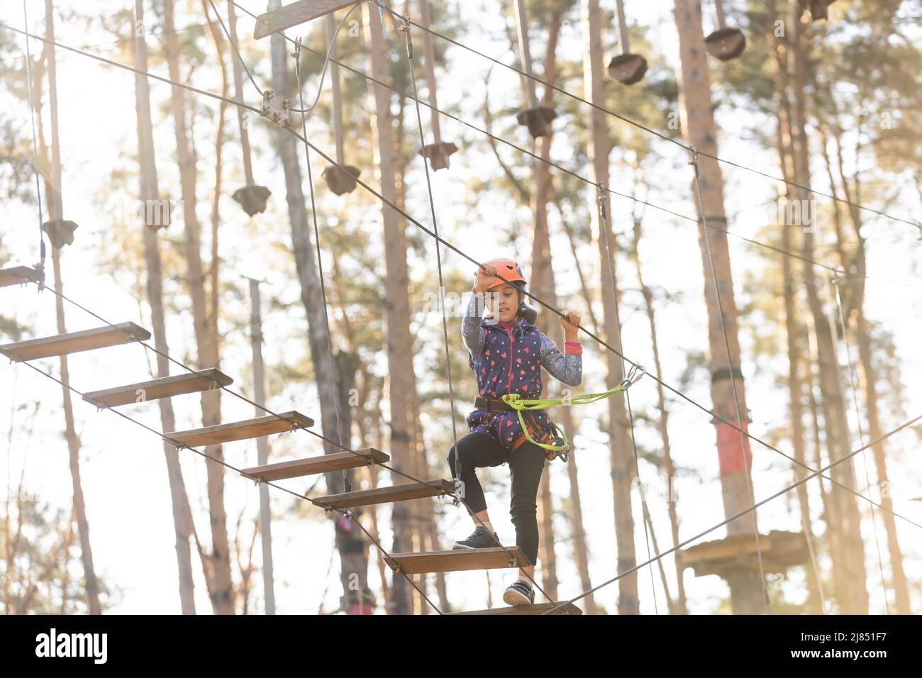 Girl Standing With Rope Little girl is standing on a rope, holding a rope with his hands. A ...