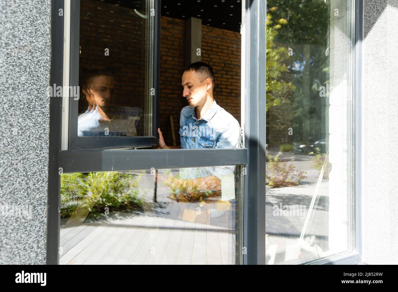 Construction worker installing window in house Stock Photo