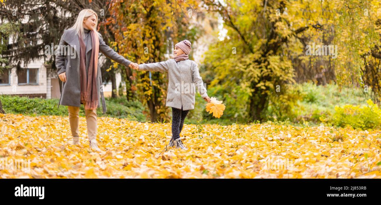 Mother and daughter in autumn yellow park Stock Photo - Alamy