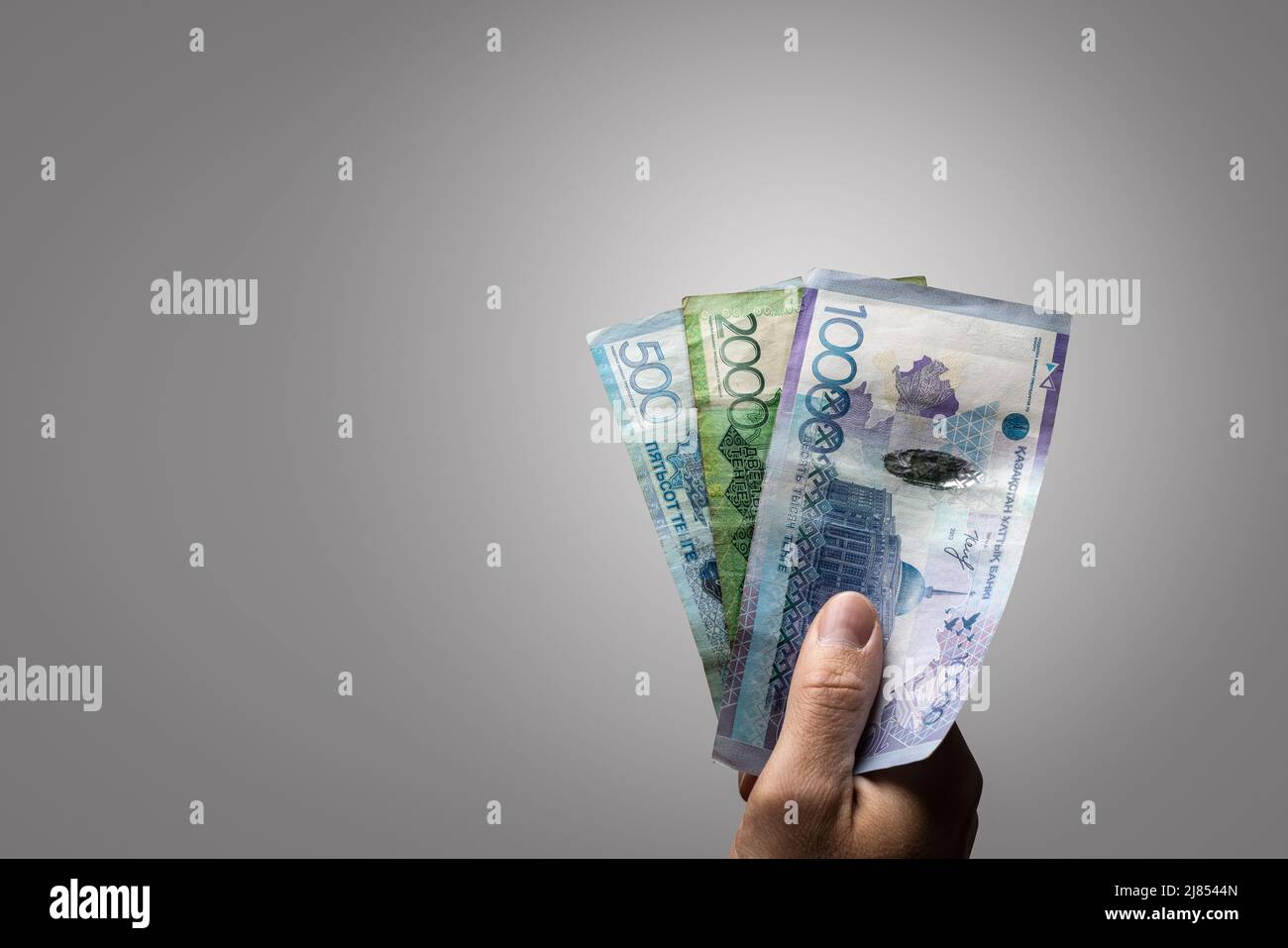 Kazakh Tenge banknotes held by a hand Stock Photo