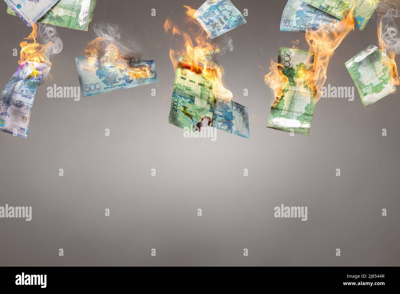 Burning Kazakh Tenge banknotes Stock Photo