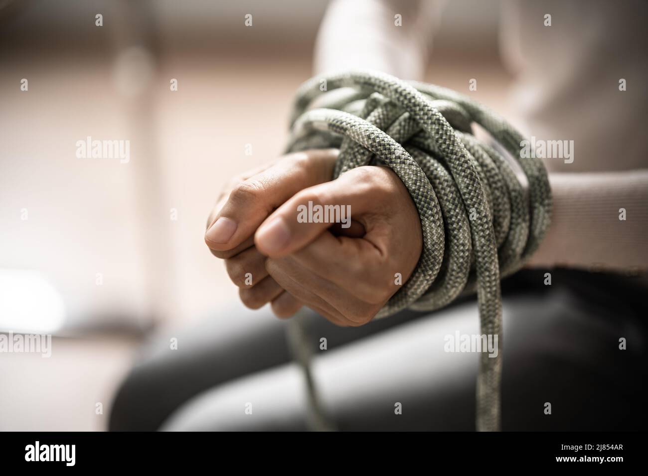 Slavery Victim And Hostage Tied By Rope. Violence And Crime Stock Photo ...