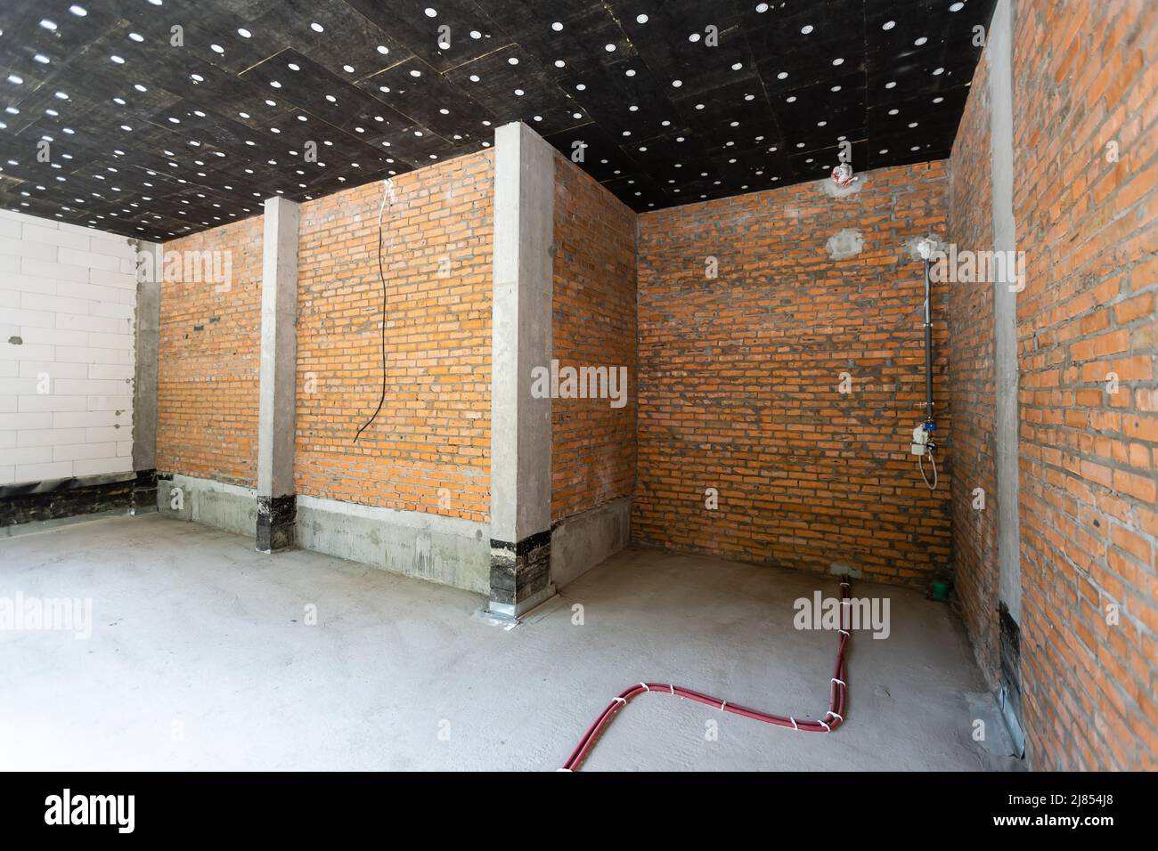 large spacious room, illuminated by natural light from windows, Empty interior space Stock Photo