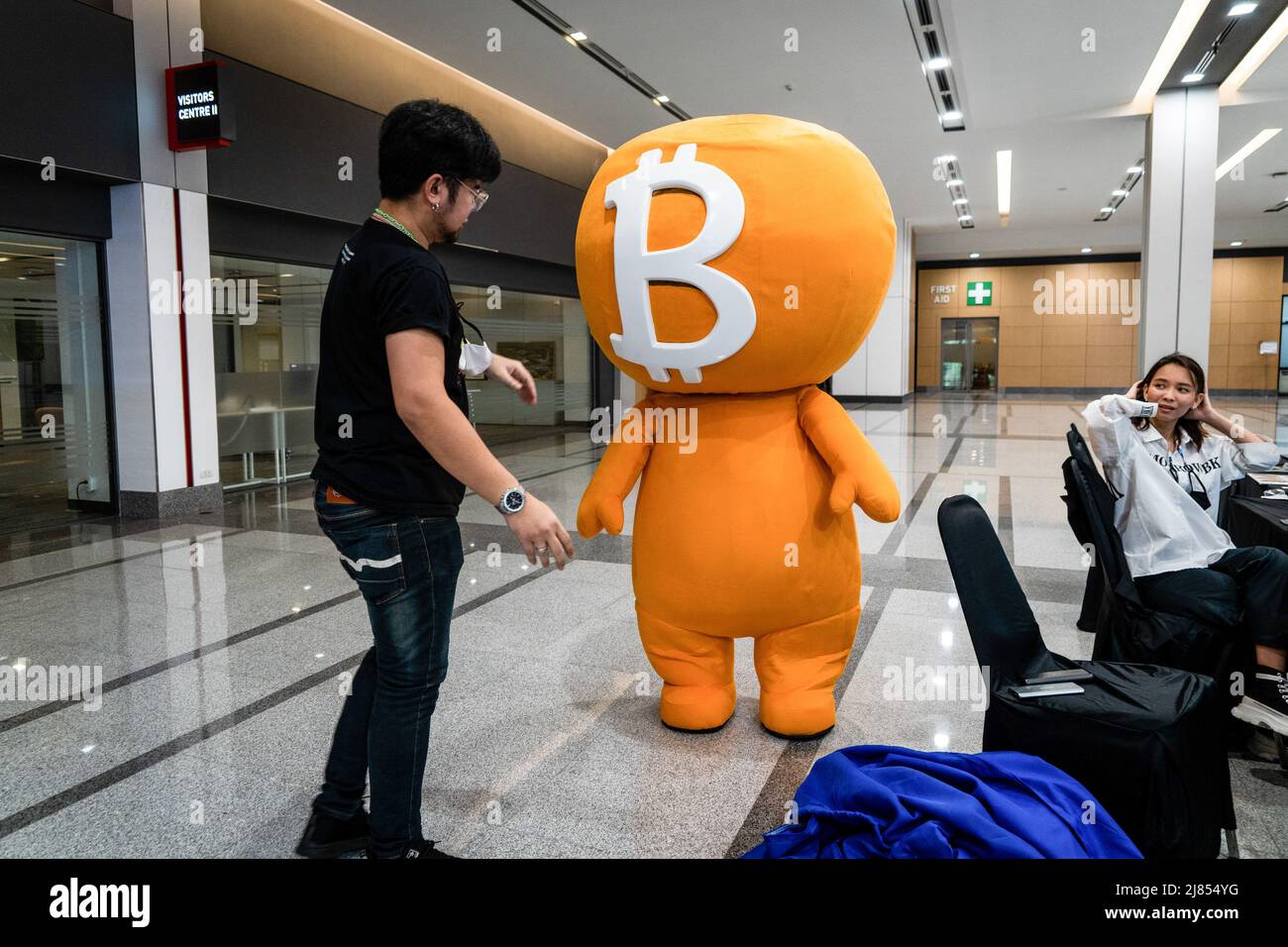 A worker helps to put the headpiece on top of a performer in a Bitcoin  (BTC) costume at Thailand Crypto Expo 2022. People attend Thailand Crypto  Expo 2022 at Bangkok International Trade