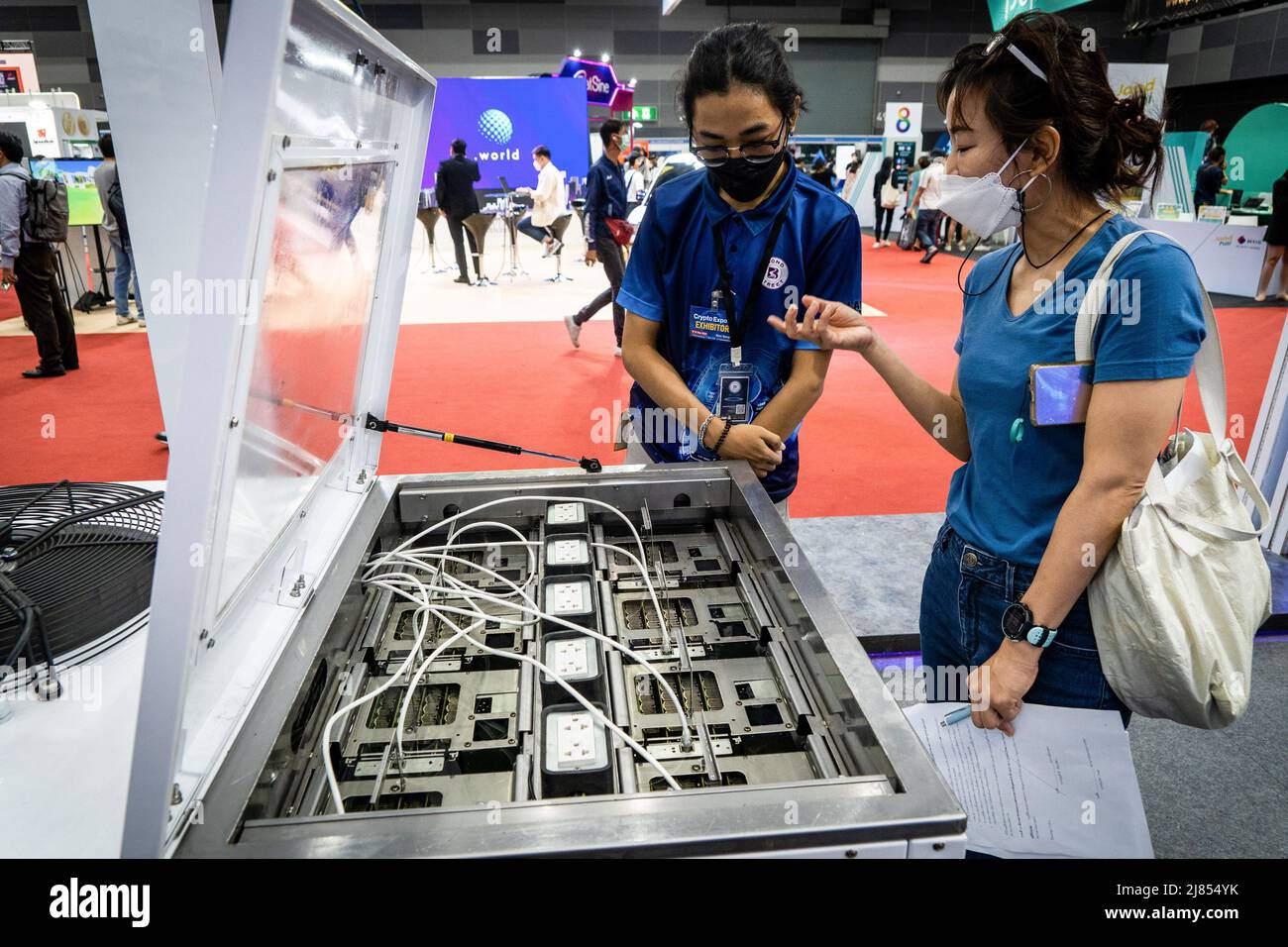 Bangkok, Thailand. 13th May, 2022. A worker demonstrates their product at  Thailand Crypto Expo 2022. People attend Thailand Crypto Expo 2022 at  Bangkok International Trade & Exhibition Centre (BITEC) in Bangkok. The