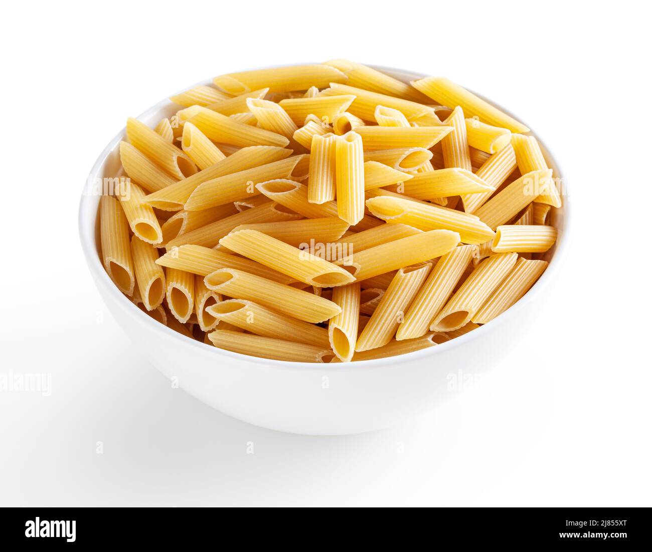Uncooked penne pasta in white bowl isolated on white background with