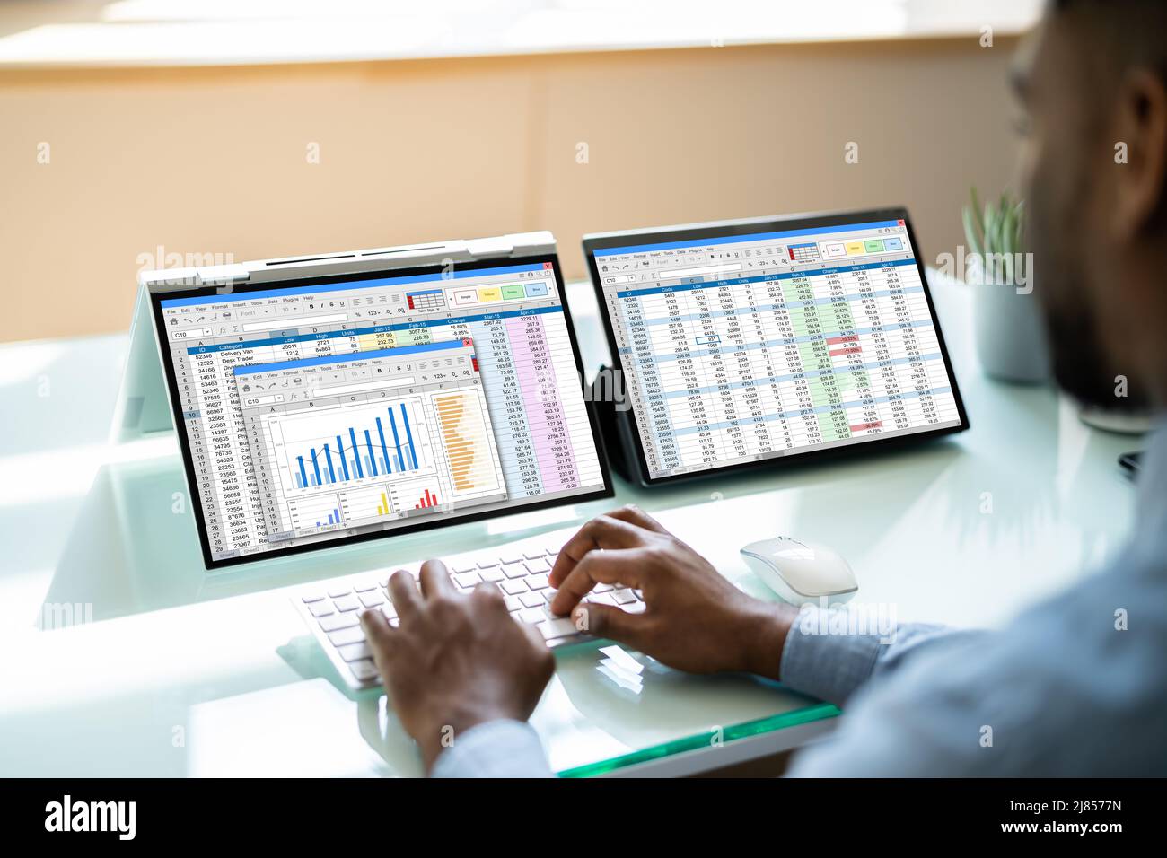 African American Analyst Using Spreadsheet On Screen Stock Photo