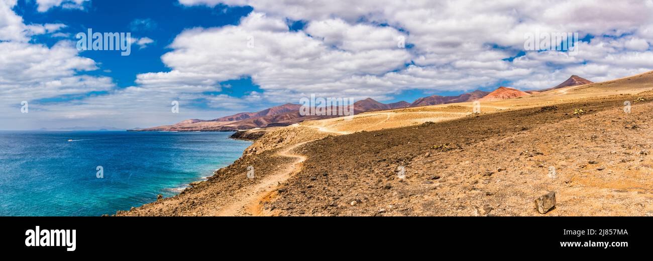 Panoramic view across the sea from Puerto Calero, looking across to Playa Quemada, Lanzarote, Spain with Fuerteventura in the distance Stock Photo