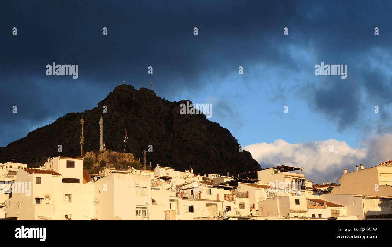 Dark rain clouds over white Andalusian village of Alora, Spain Stock Photo