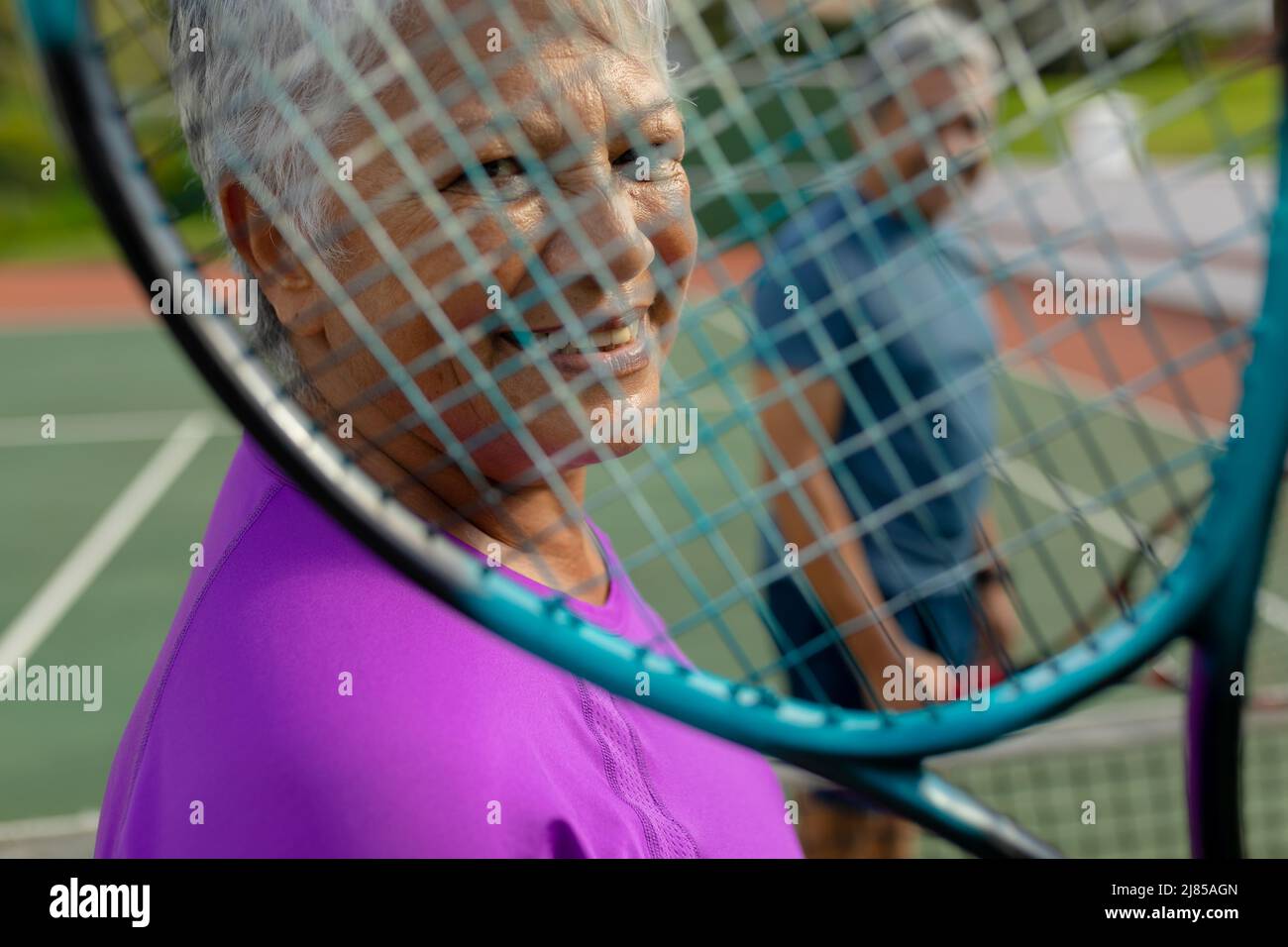 Closeup portrait of biracial smiling senior woman with man looking