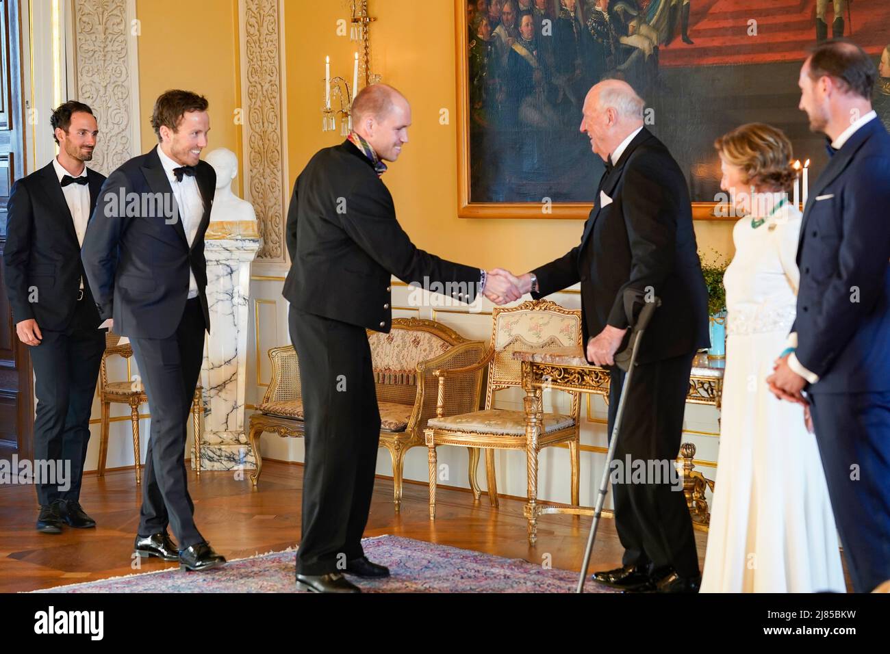 Oslo 20220512.King Harald greets Paal Golberg before the dinner the royal couple holds for the athletes from the Olympics and Paralympics in Beijing at the Palace. Behind follow Emil Iversen and Hans Christer Holund. Photo: Terje Bendiksby / NTB Stock Photo
