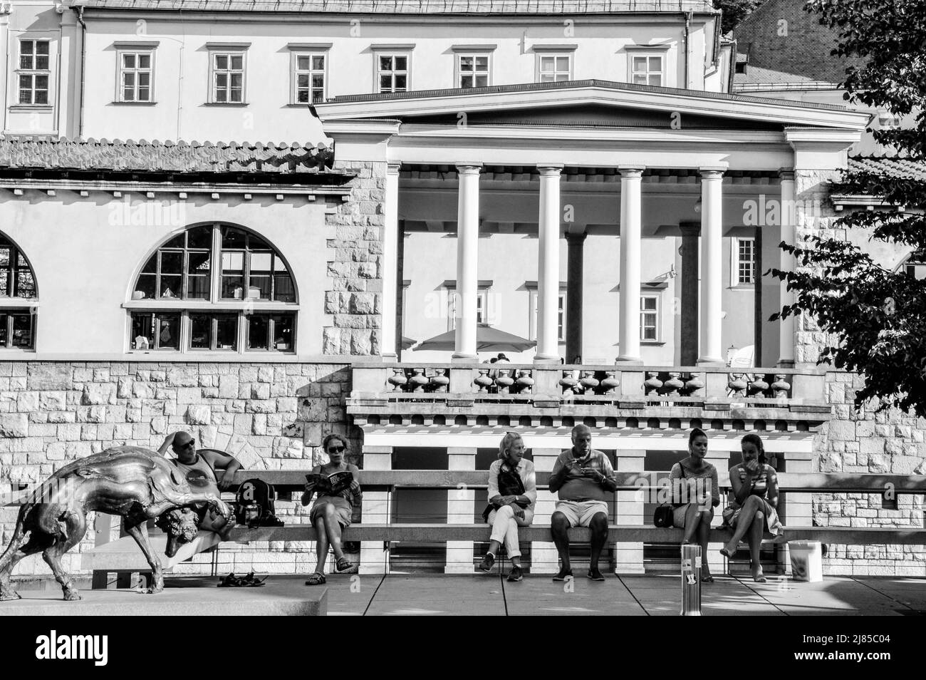 Locals sitting on a bench in the city center of Ljubljana Stock Photo